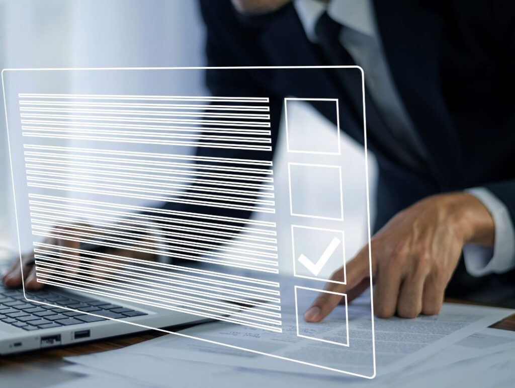 The image shows a SciencePharma employee carefully reviewing the Summary of Product Characteristics (SmPC), Product Information (PI), and a package leaflet. The verification process ensures that these documents comply with legal criteria and guidelines before being submitted to the Registration Authorities. The employee is focused on checking the accuracy, readability, and consistency of the content, as well as ensuring that the mock-ups visually represent the approved labelling and leaflet. This thorough review is crucial for patient safety and the proper use of the medicinal product.