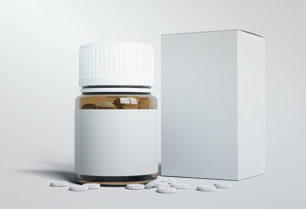 The image shows a medicine package with tablets scattered around it. The package is blank, without any informational leaflet or labeling, as it has yet to undergo verification by SciencePharma. This process will ensure the Product Information (PI), including the summary of product characteristics (SmPC), package leaflet, and labeling, is thoroughly reviewed and meets the legal criteria for readability and compliance. SciencePharma's experts will verify the mock-ups, ensuring they align with national and European guidelines before submission to the relevant Registration Authorities. This crucial step guarantees that the final packaging and leaflets will be accurate, legible, and safe for patient use.